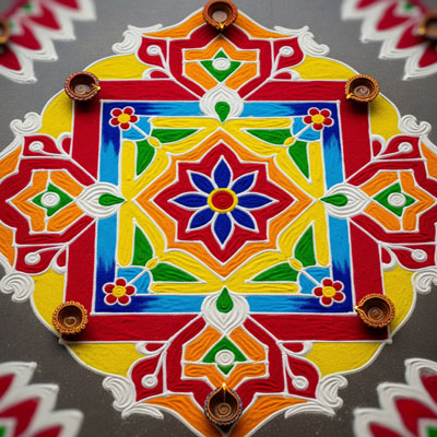 Colorful Diwali rangoli design with diyas