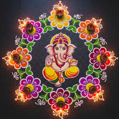 A vibrant Diwali rangoli design featuring Lord Ganesha, colorful floral patterns, and lit diyas.
