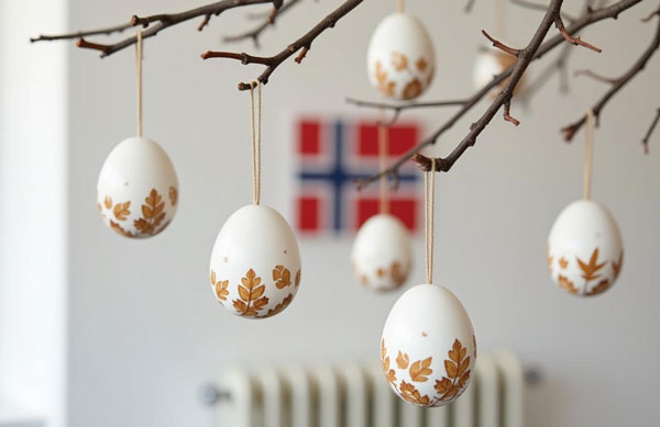 Colorful Easter eggs hanging from a leafy branch, symbolizing the festive spirit of Easter celebrations in Norway