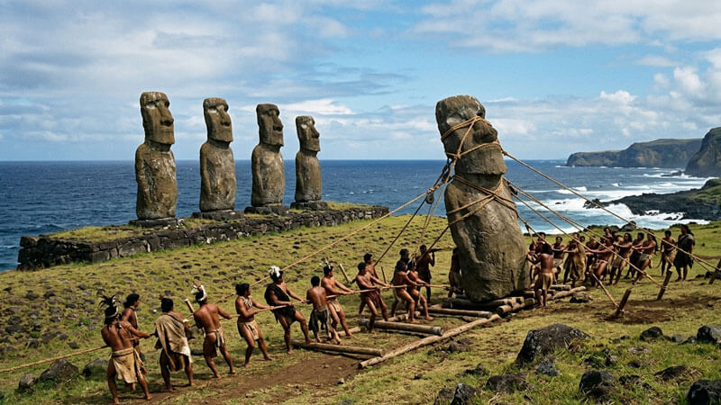 Row of giant moai stone statues on the coast of Easter Island